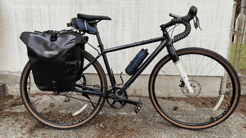 My Priority Apollo gravel bike with a rack, panniers, and a kickstand installed.