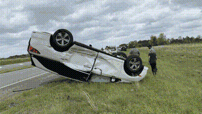 Our minivan, totalled and upside-down on the side of the road.
