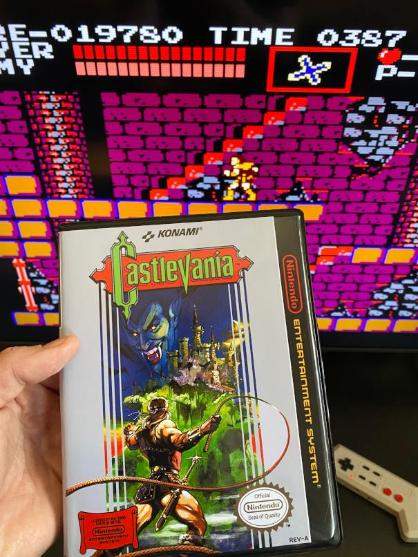 the box art for castlevania, with the game in the background.